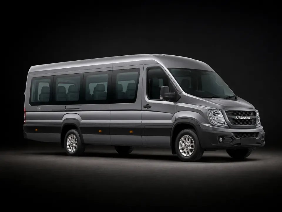 A 17 seater Force Urbania in near profile against a dark studio backdrop